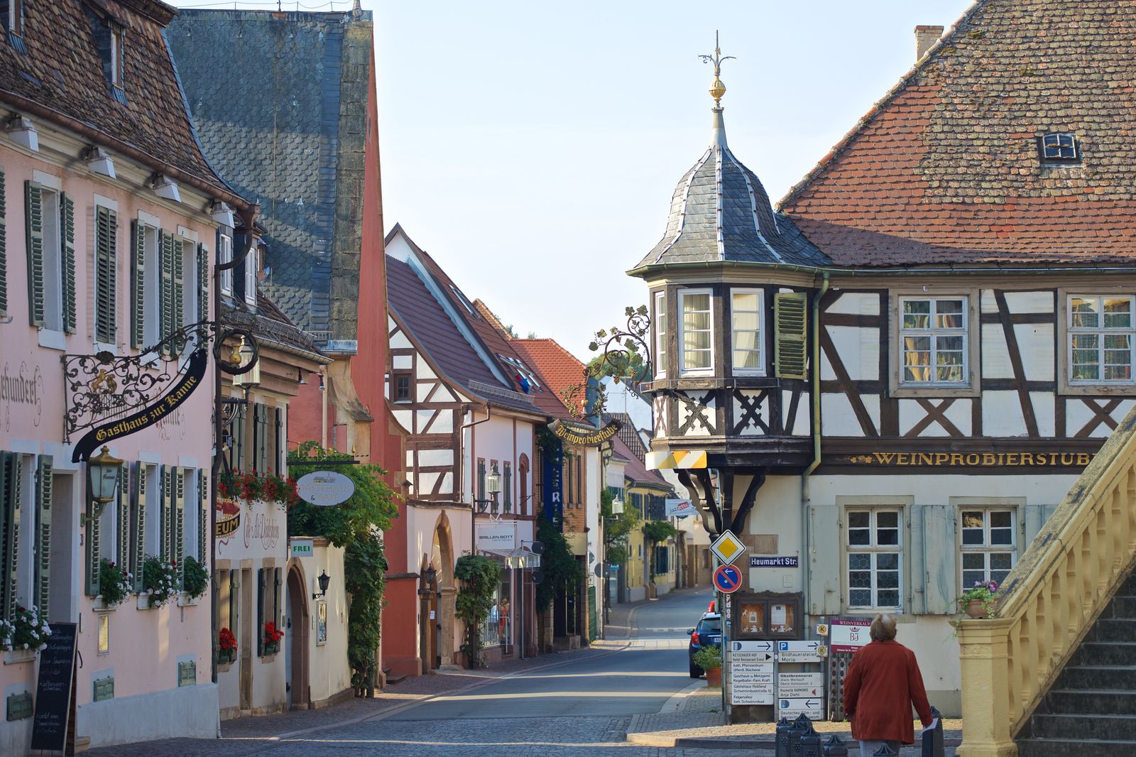 A charming German wine town street scene with traditional half-timbered buildings, identified as Deidesheim through