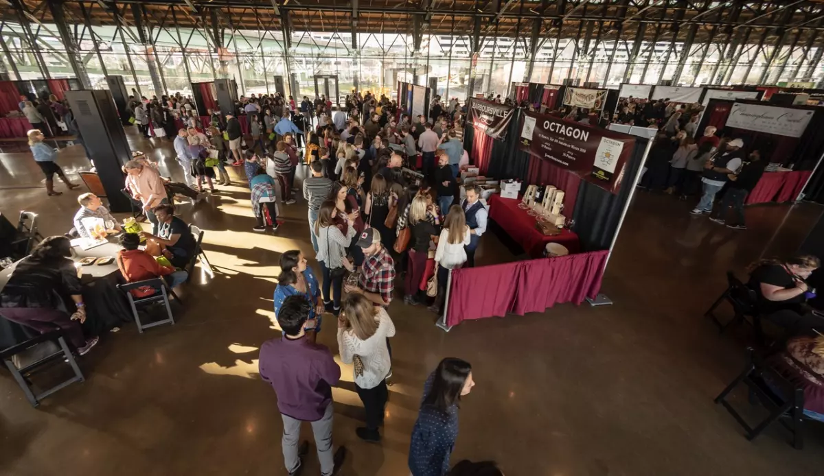 The Grand Tasting showcases many booths draped in rich, dark red fabric.
