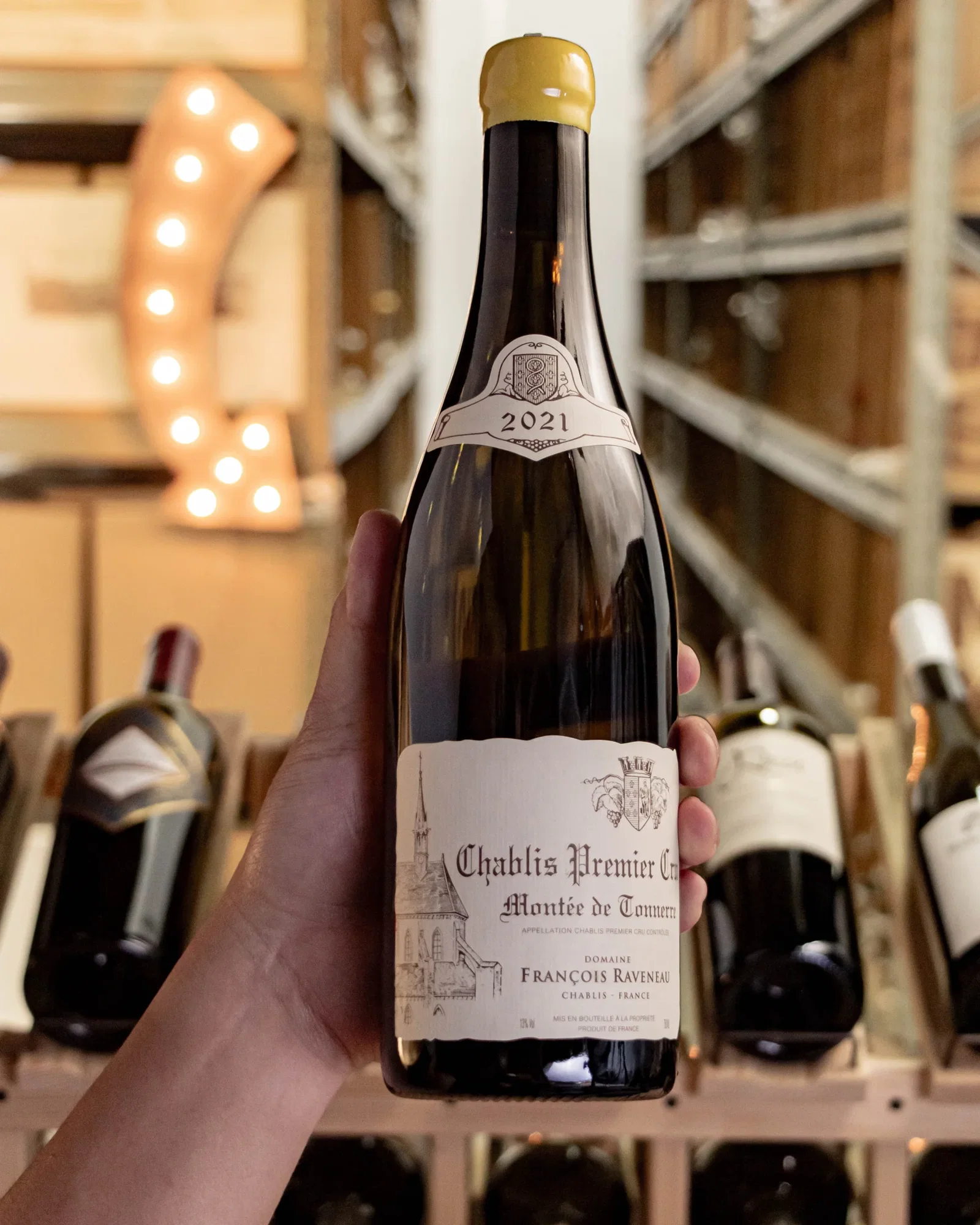 Domaine François Raveneau features a distinctive yellow wax capsule on its bottle.