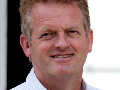 A professional portrait of Gavin Quinney, owner and winemaker of Chateau Bauduc, smiling at the camera.