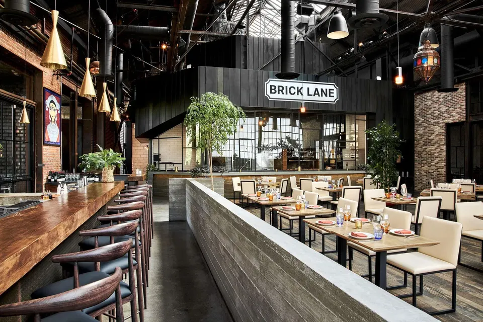 Brick Lane (Arts District) features a striking concrete divider separating the dining areas.