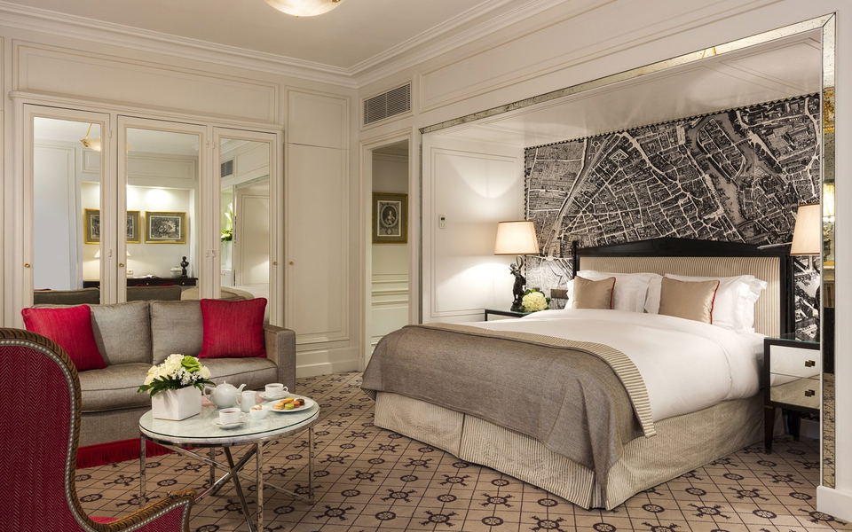 St. Regis Paris luxury suite interior bedroom with classic Parisian decor.