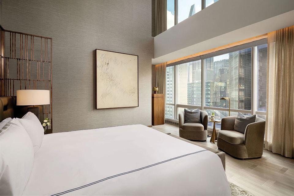 Park Hyatt New York luxury suite interior with floor-to-ceiling windows and modern furnishings.
