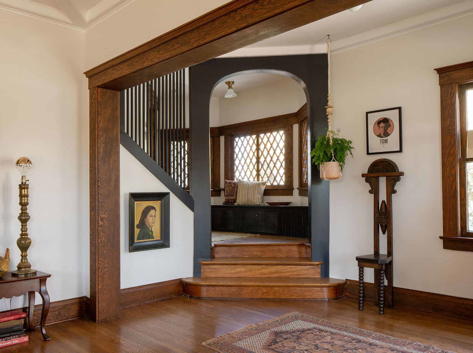 Key Details for Your Stay, showcasing a striking dark arched doorway leading to a cozy window seat.