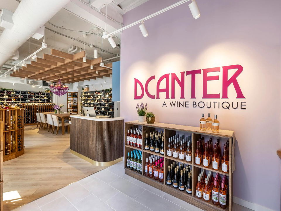 DCanter (Old Town Alexandria) offers a cellar-style interior with a communal tasting table and extensive wine displays.