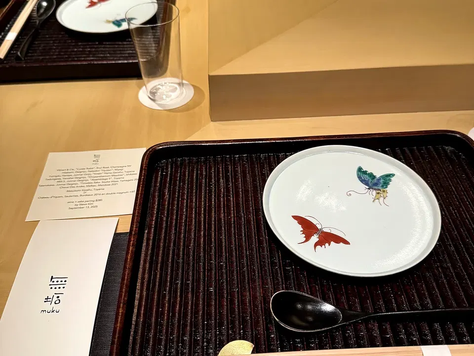Japanese place setting with a painted fish plate at Muku’s counter