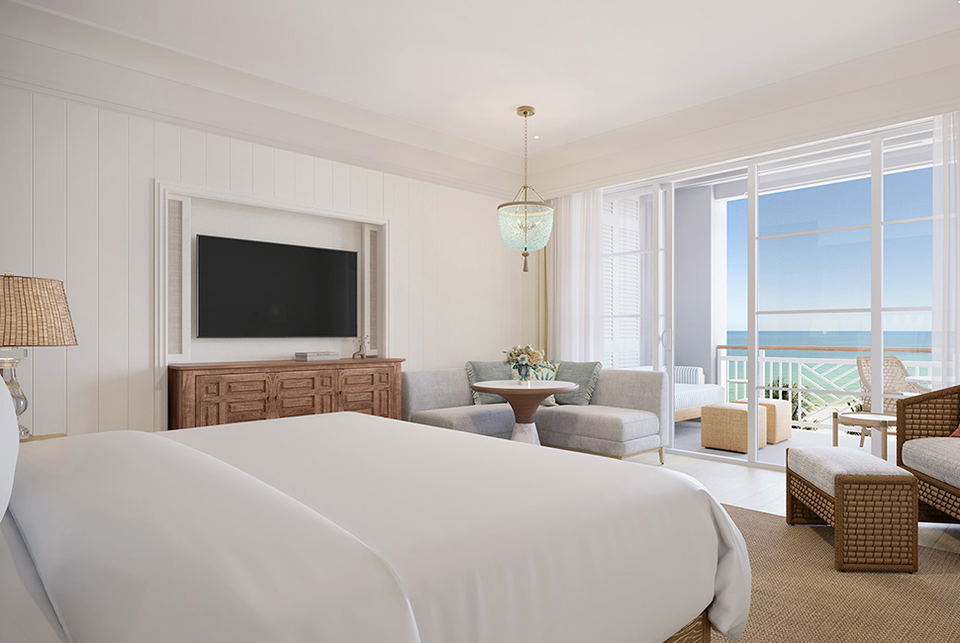 A luxury hotel bedroom with ocean view balcony
