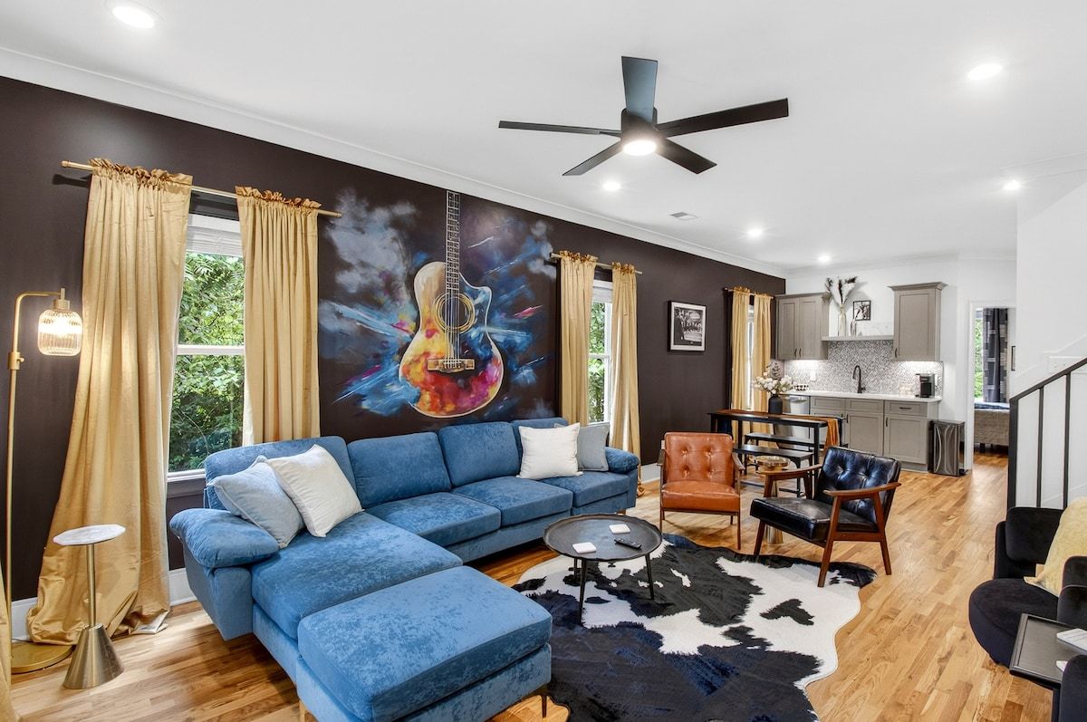 Cozy Speakeasy Charm Meets Modern Nashville Energy, featuring a striking colorful guitar mural.