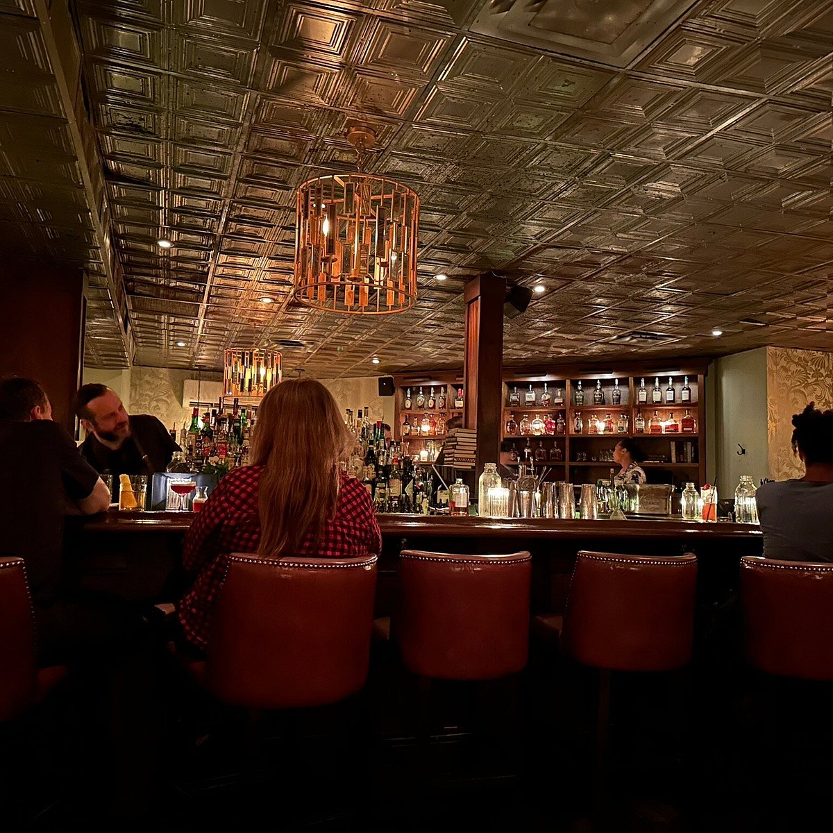 Our 2026 Review of The Patterson House features the striking metallic pressed tin ceiling.