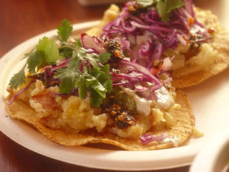 Seedy's papa tostadas, vibrant with slaw and salsas, offer a taste of Lincoln Heights.