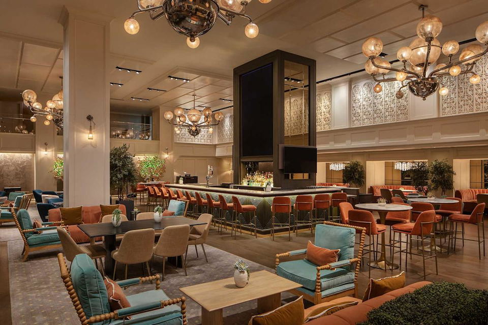 What’s Next for NYC Central Park Hotels, featuring a sophisticated bar and lounge with warm lighting.