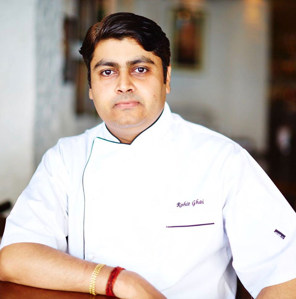 Professional portrait of a chef in white chef's coat with 'Rohit Ghai' embroidered on the chest