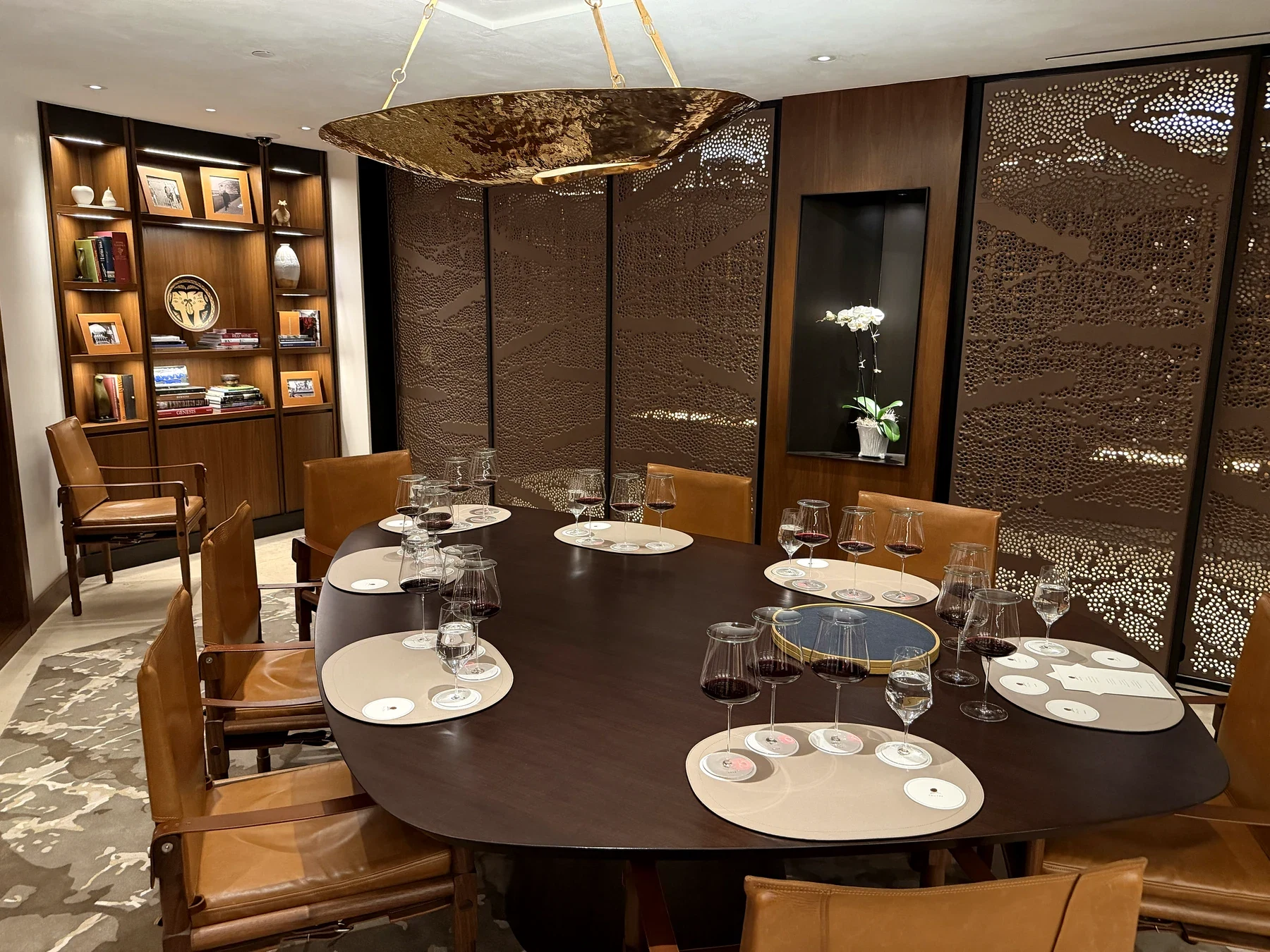 Private Opus One tasting table set with multiple red-wine glasses beneath a bronze light