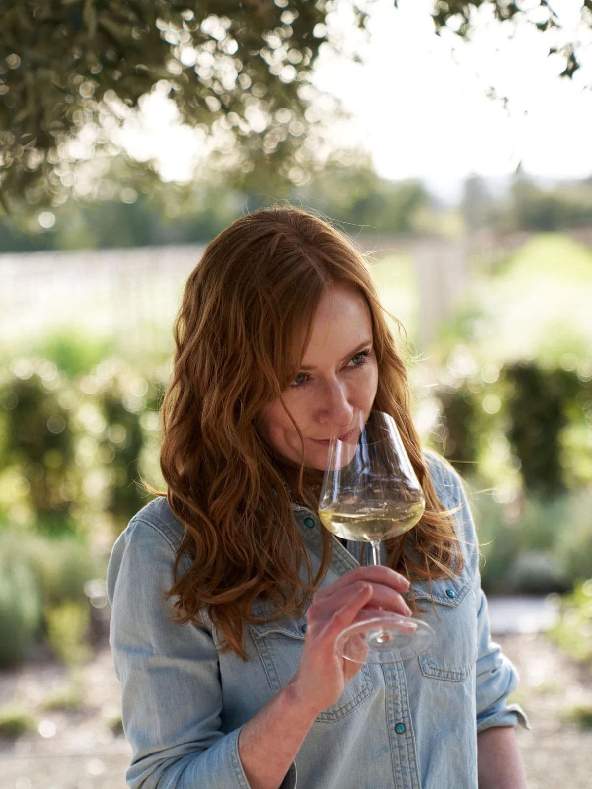 Meghan Zobeck, director of winemaking at Opus One, tasting wine in the estate vineyard