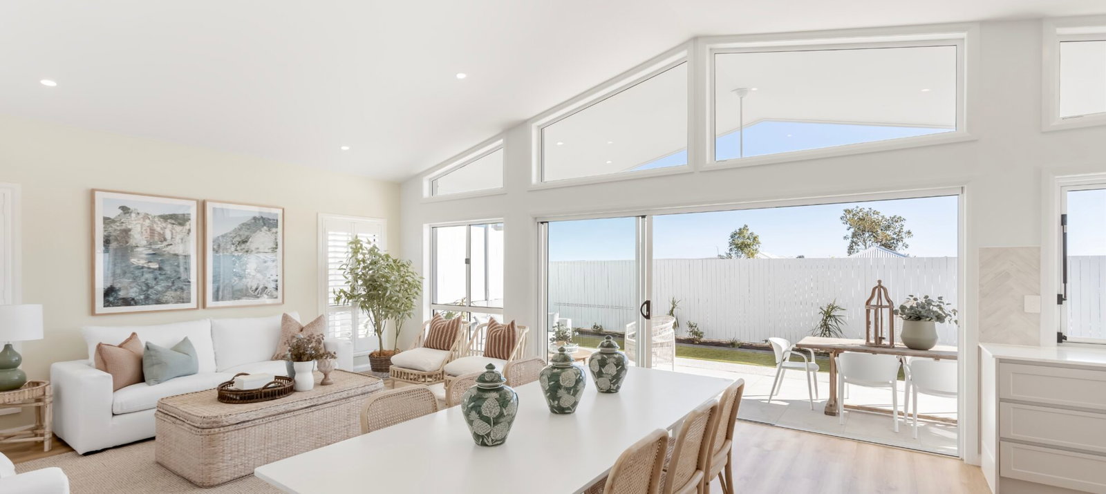Planning Your Visit, featuring a bright, open living area with expansive floor-to-ceiling windows.