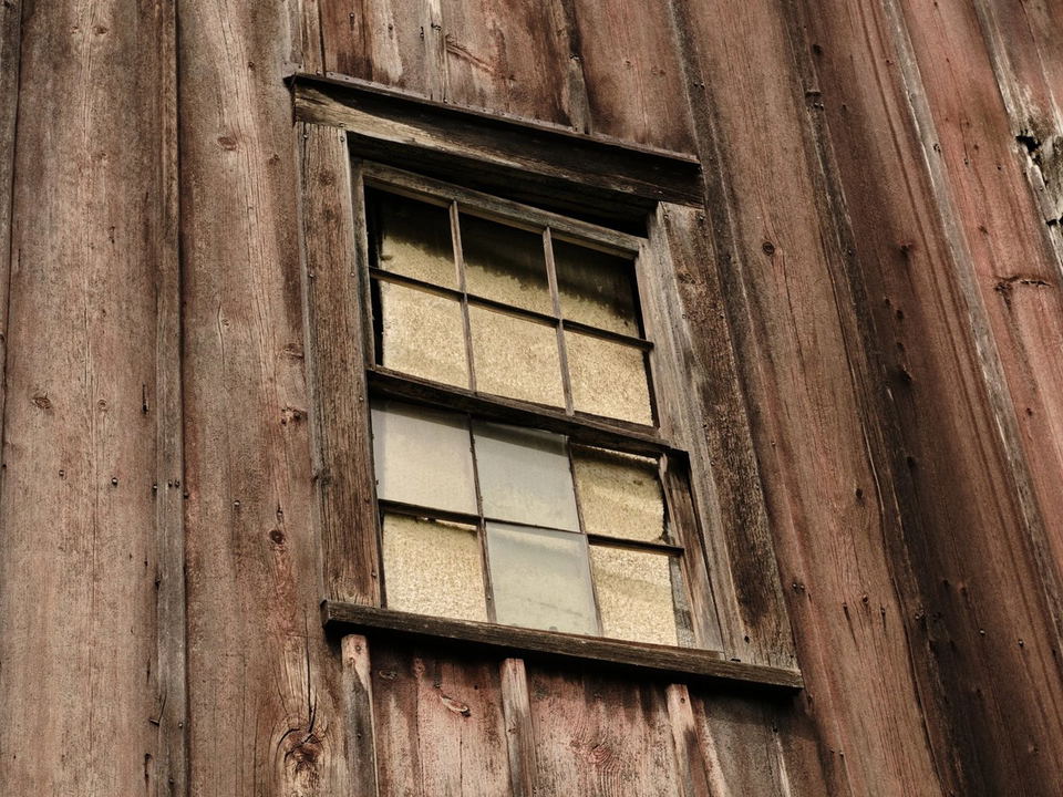 Crown Daisy Farm, a produce supplier for Oyatte, features rustic charm with its weathered wood and old window.