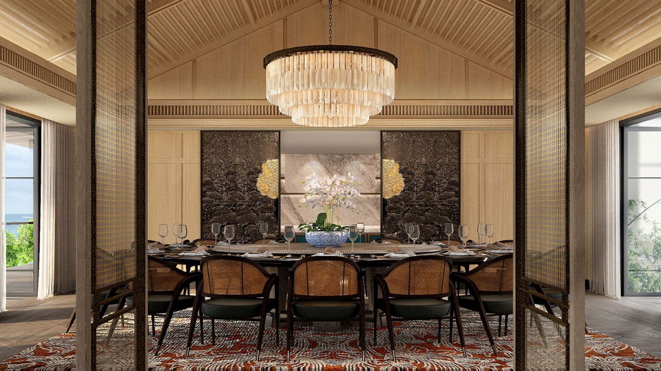 A luxurious dining room with a large table set for formal dining, featuring a tiered crystal chandelier, decorative wall panels with gold accents, and