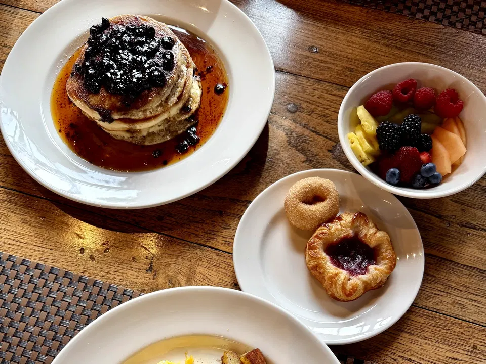 Huckleberry pancakes with fresh fruit and breakfast pastries at Paws Up