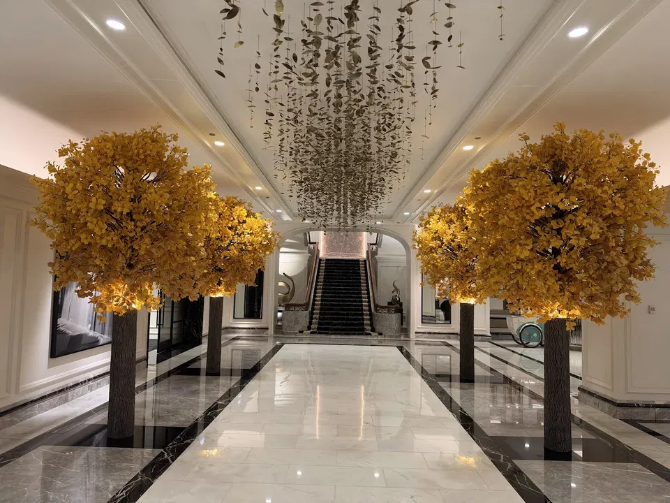 Autumn-yellow floral displays and suspended artwork in the Four Seasons Chicago arrival hall