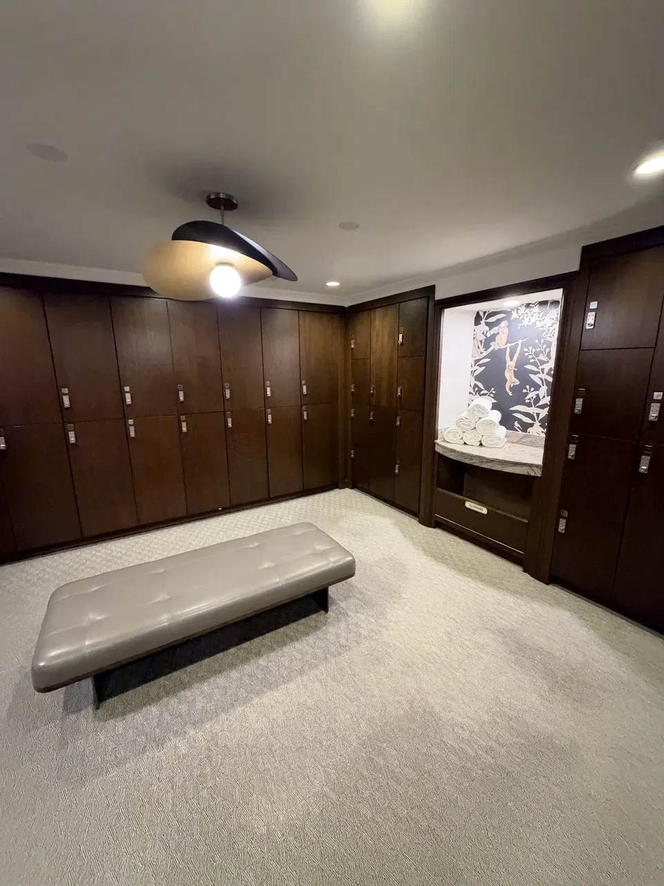 Wood-lined changing area with a bench and towels in the hotel spa