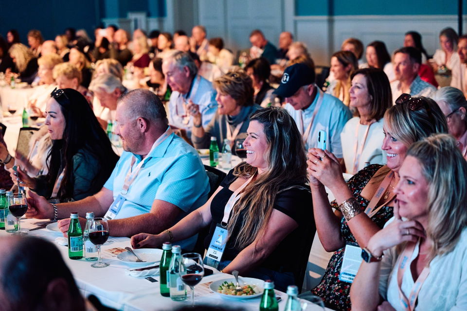 Seated guests with plates and wine glasses at a previous Food and Wine Classic in Charleston