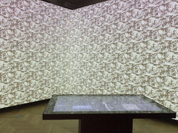 The Cooper Hewitt Immersion Room projects wallpaper designs onto walls, enhancing the interactive table experience.