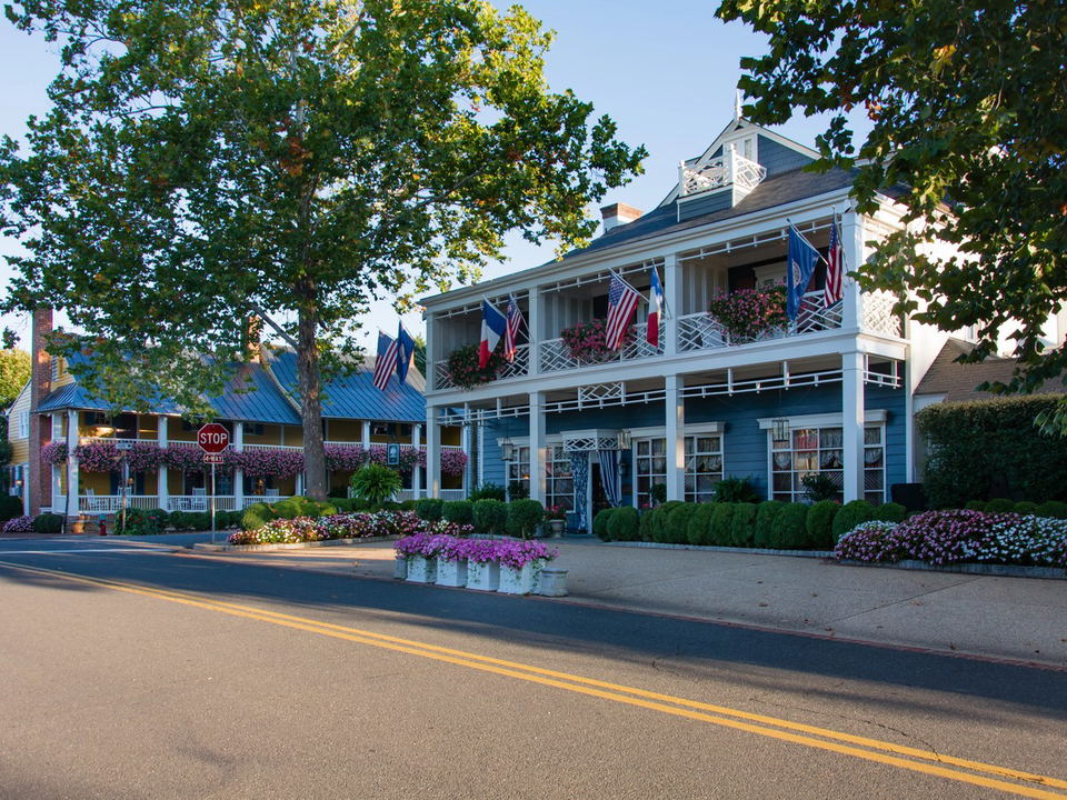 The Inn at Little Washington exterior with flags and flower planters.