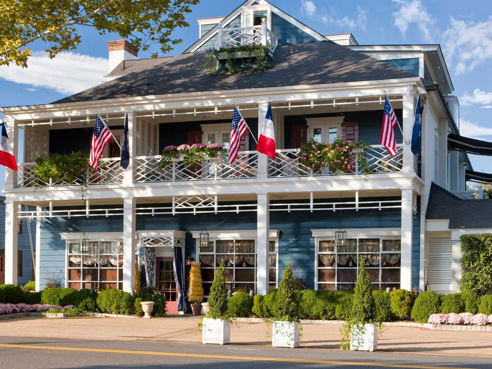 The Inn at Little Washington exterior with flags and flower boxes.