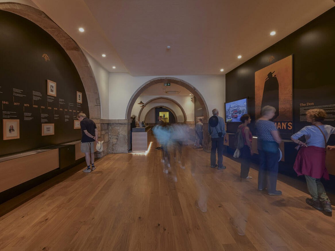 Douro Valley visitors explore the Sandeman Lodge's atmospheric exhibition space.
