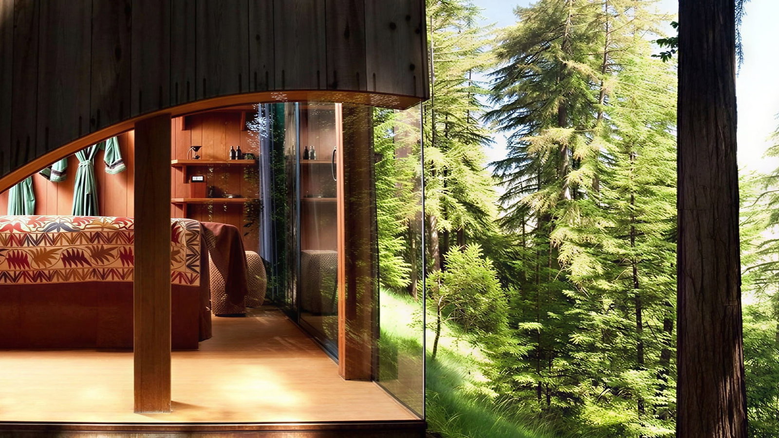 A modern room with a large glass wall looking out onto a dense forest of tall green trees. Inside, a bed with a colorful patterned blanket and wooden.