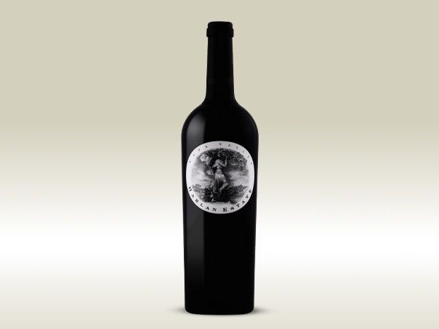 A dark wine bottle with a circular black-and-white label featuring a figure under a tree, with 'Napa Valley' and 'Harlan Estate' visible on the label.