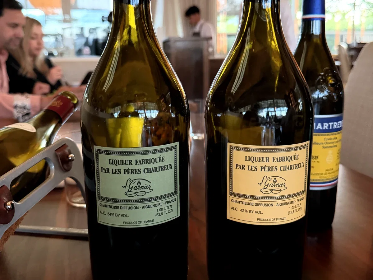 Green and yellow Chartreuse bottles presented after dinner at PRESS