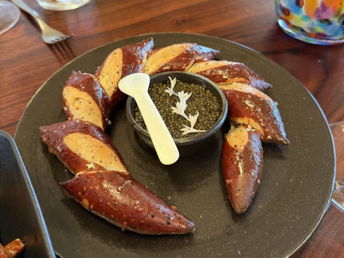 Warm caviar pretzel with cultured yogurt butter at PRESS Restaurant