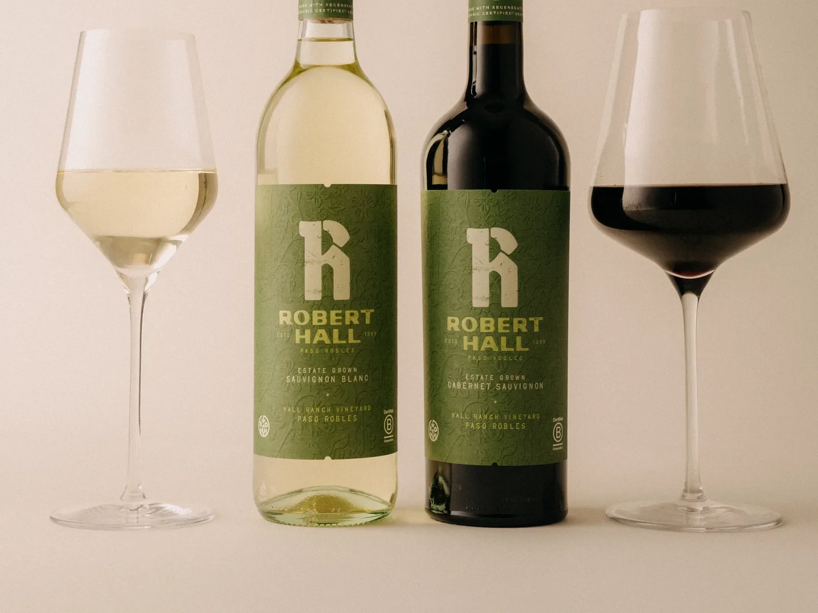 Two bottles of Robert Hall wine with glasses of white and red wine.