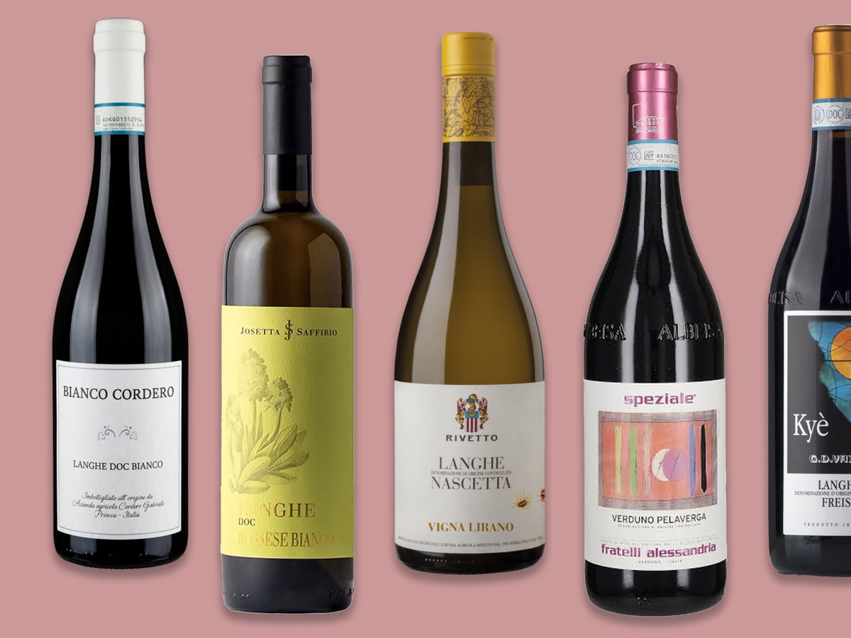 Five wine bottles displayed against a pink background, showing Langhe DOC wines from various producers