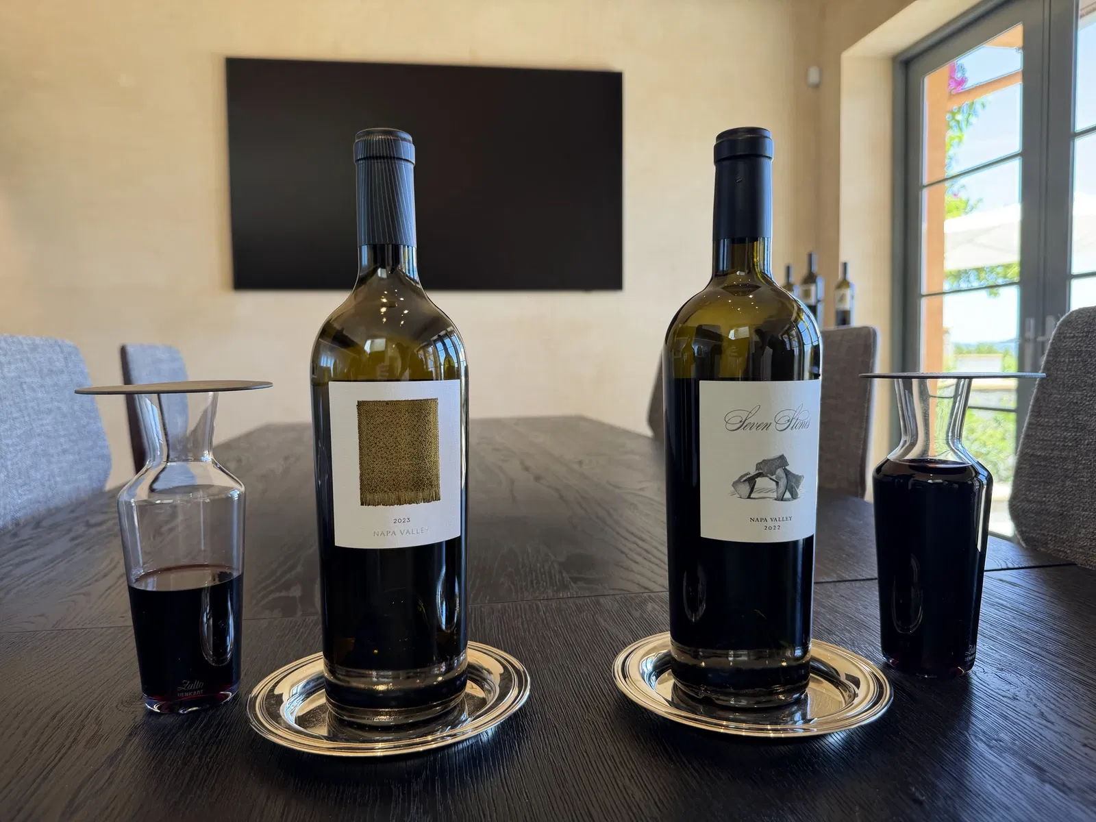 2023 The Collection and 2022 Seven Stones Estate Cabernet bottles with decanters