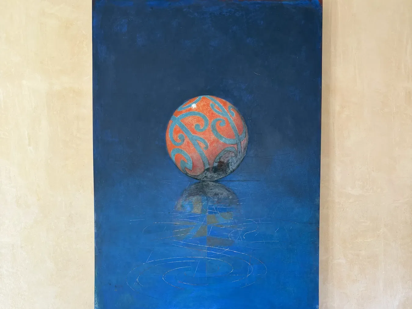 Cobalt blue painting with an orange patterned sphere inside the Seven Stones residence