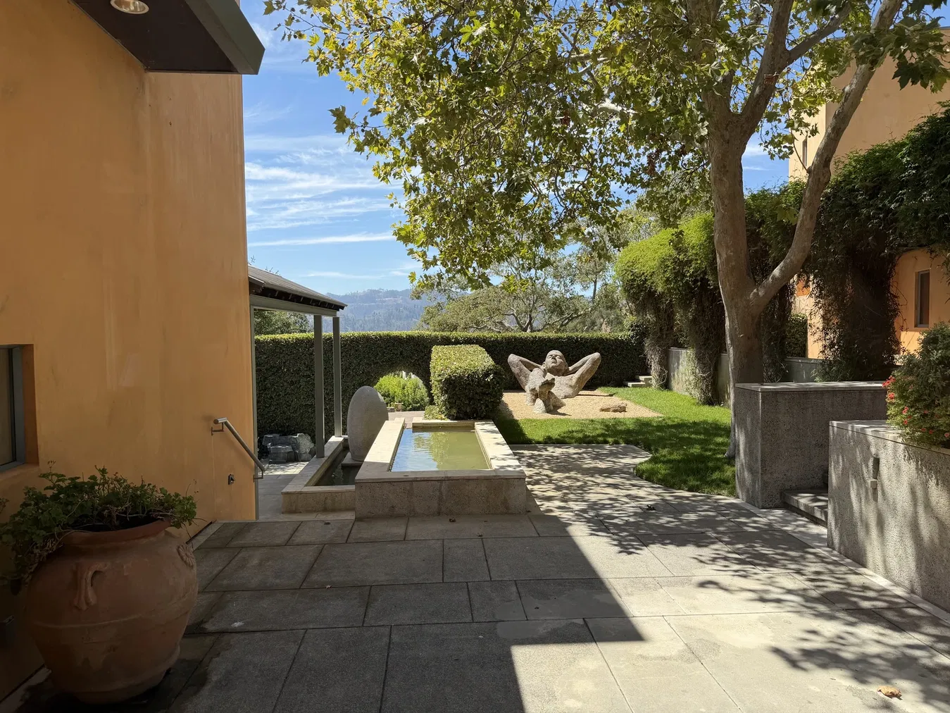 Figurative sculpture integrated into clipped garden planting at Seven Stones Estate