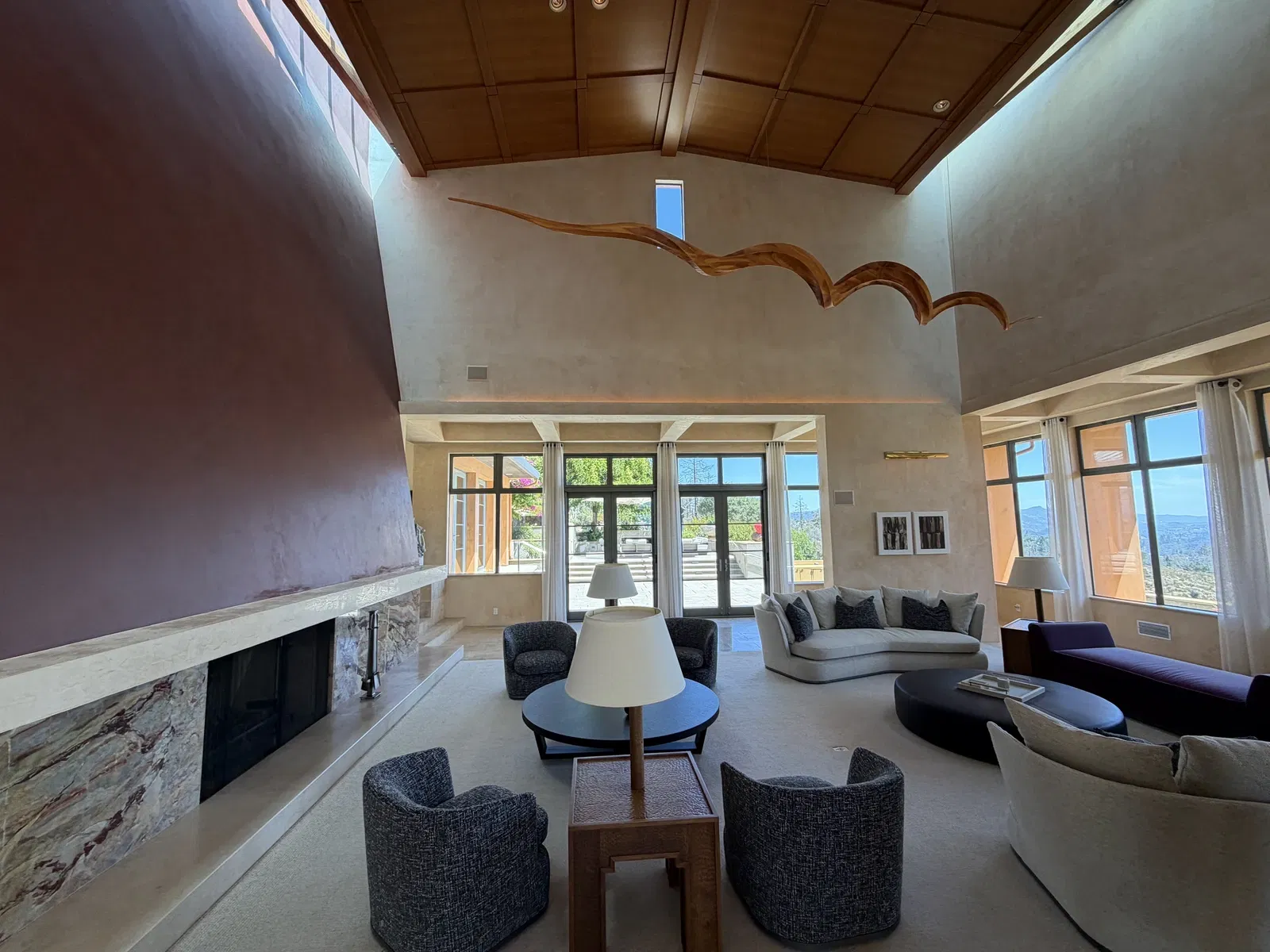 Art-filled great room with high wood ceiling and valley light at Seven Stones Estate