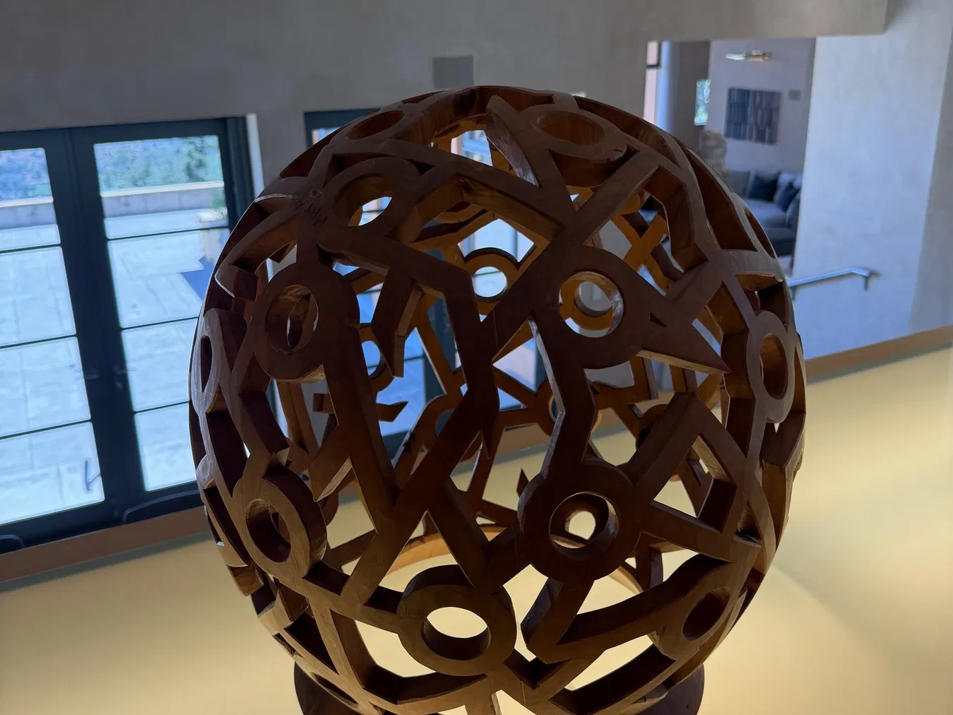Spherical suspended wood sculpture inside Seven Stones Estate
