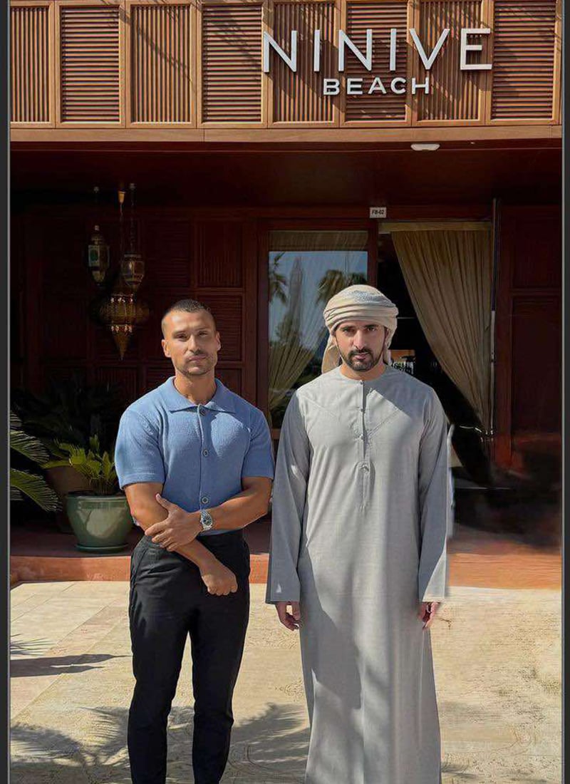 Two men stand outside Ninive Beach restaurant in Dubai.