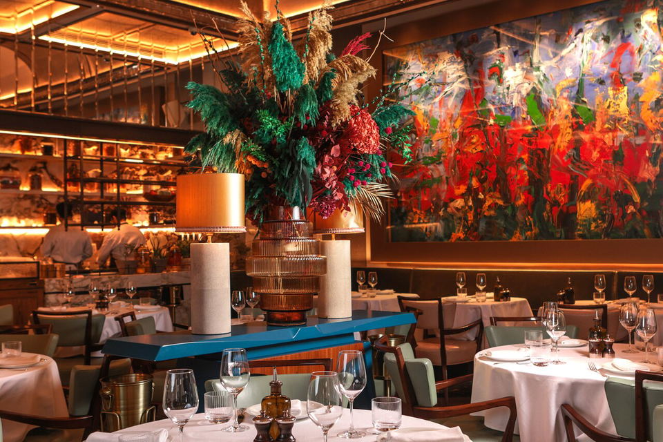 Alaya (DIFC), featuring a large abstract painting with bold red and blue hues.