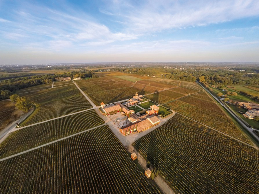 Smith Haut Lafitte: An aerial view reveals the sprawling vineyard and château under a wide sky.