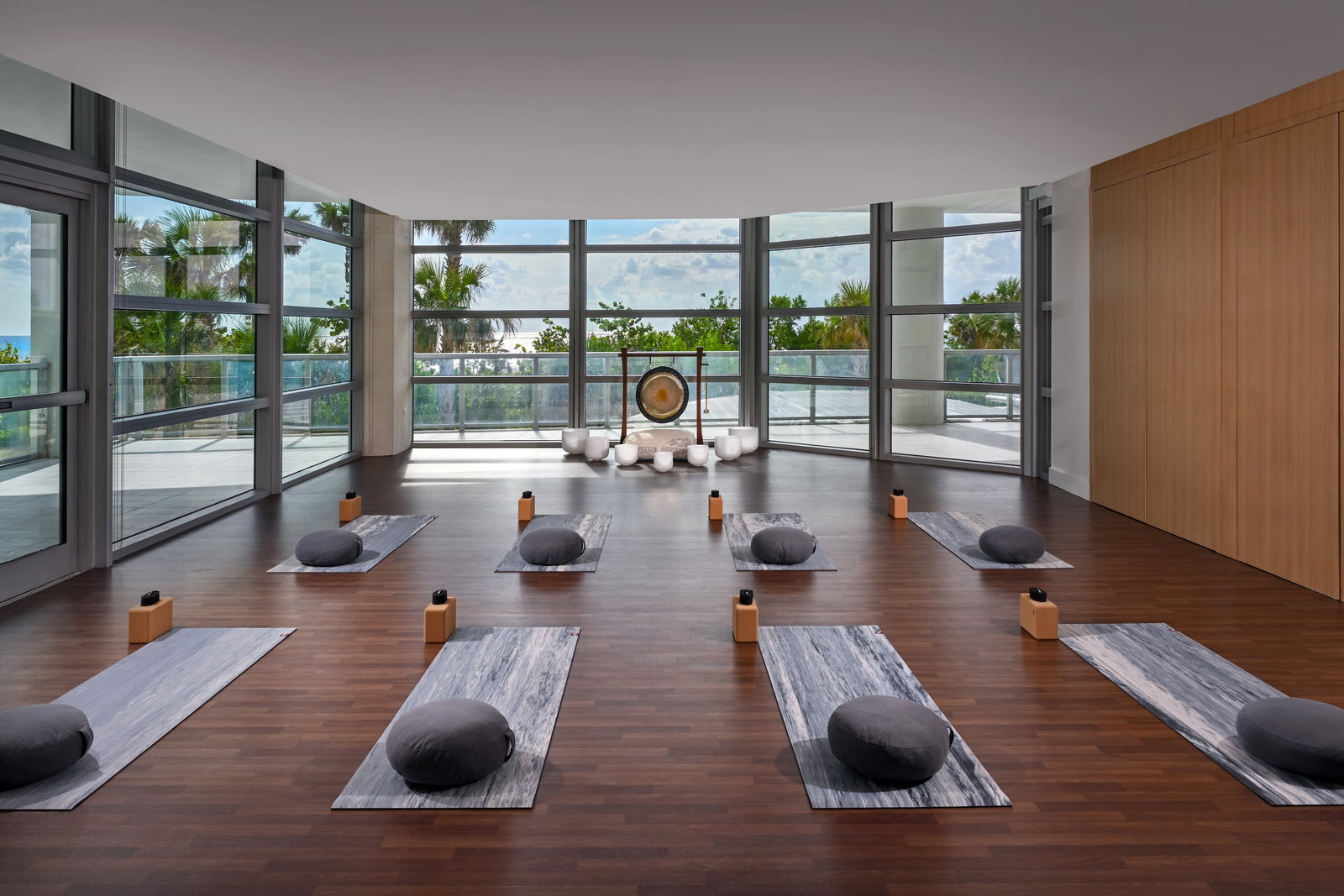 Wellness and Activities, centered by a large golden gong and several white crystal bowls.