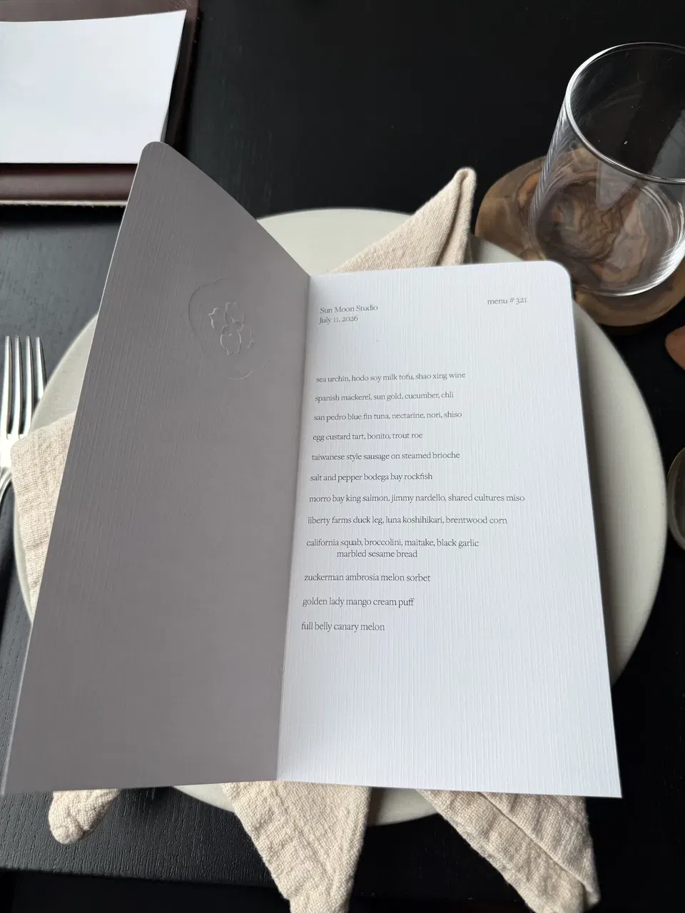 Printed Sun Moon Studio tasting menu dated July 11, 2026