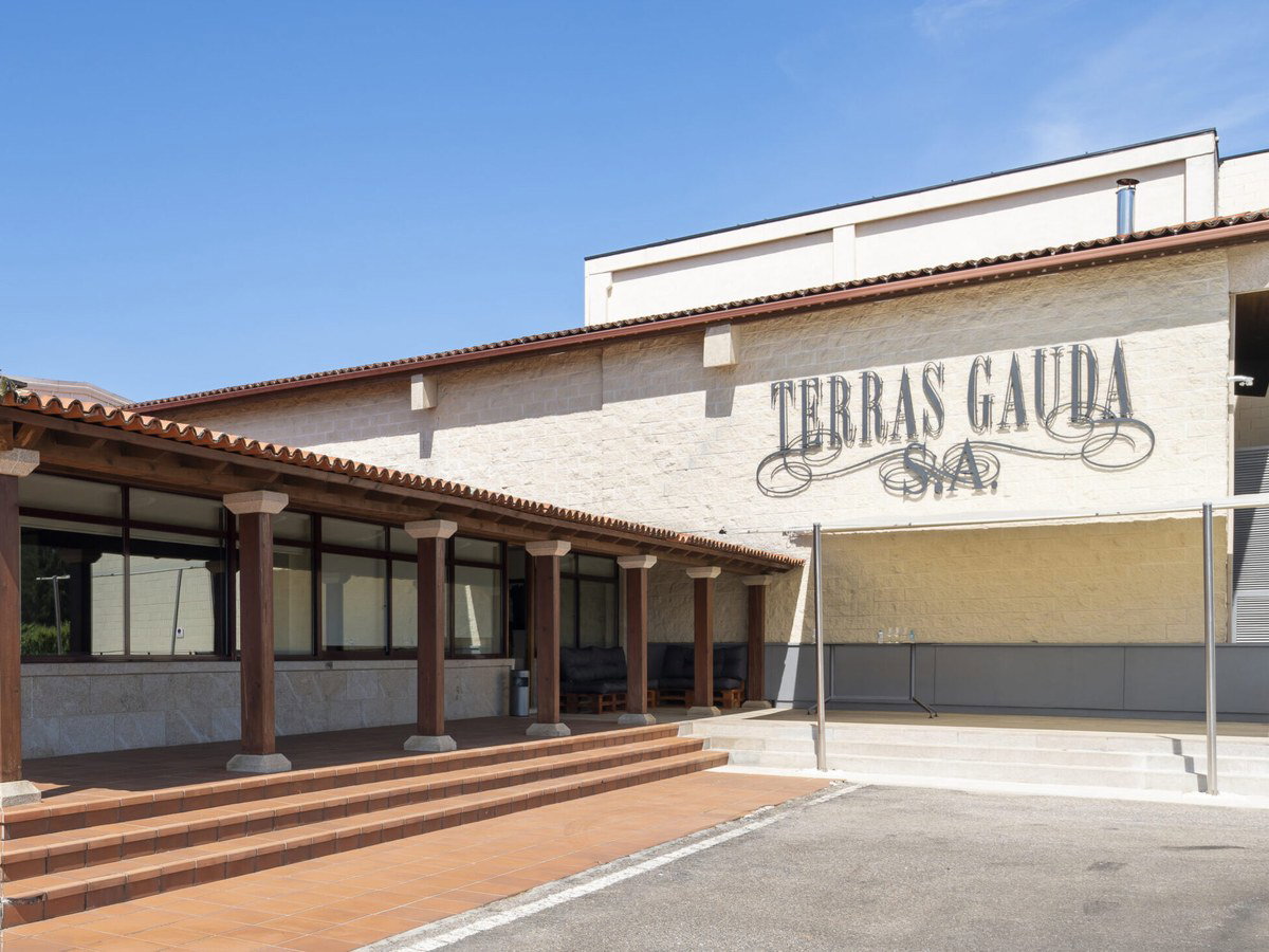 Terras Gauda S.A. winery building, featuring a covered colonnade entrance and terracotta roof tiles.