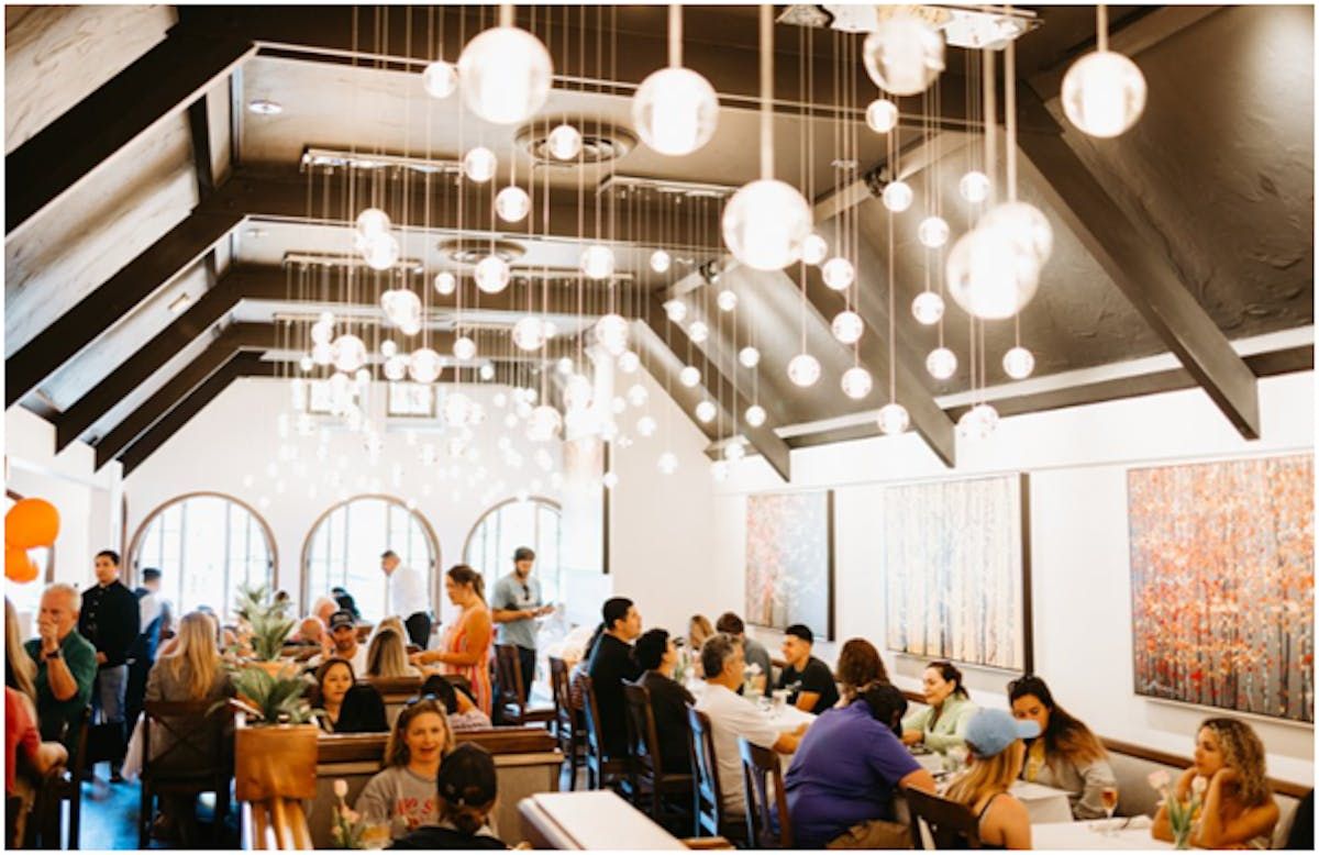 Pangaea Grill's dining room is illuminated by many hanging spherical lights.