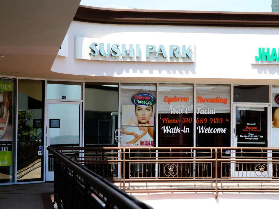 Sushi Park's understated storefront in a West Hollywood strip mall, alongside an eyebrow threading salon.