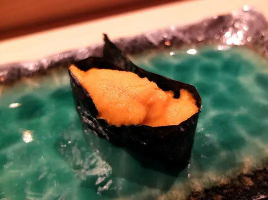 Kura's exquisite uni gunkan-maki, a highlight of their intimate 12-seat omakase experience.