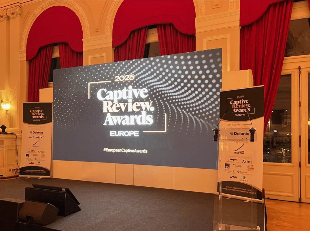 Awards and Reviews, with elegant red curtains framing the stage.